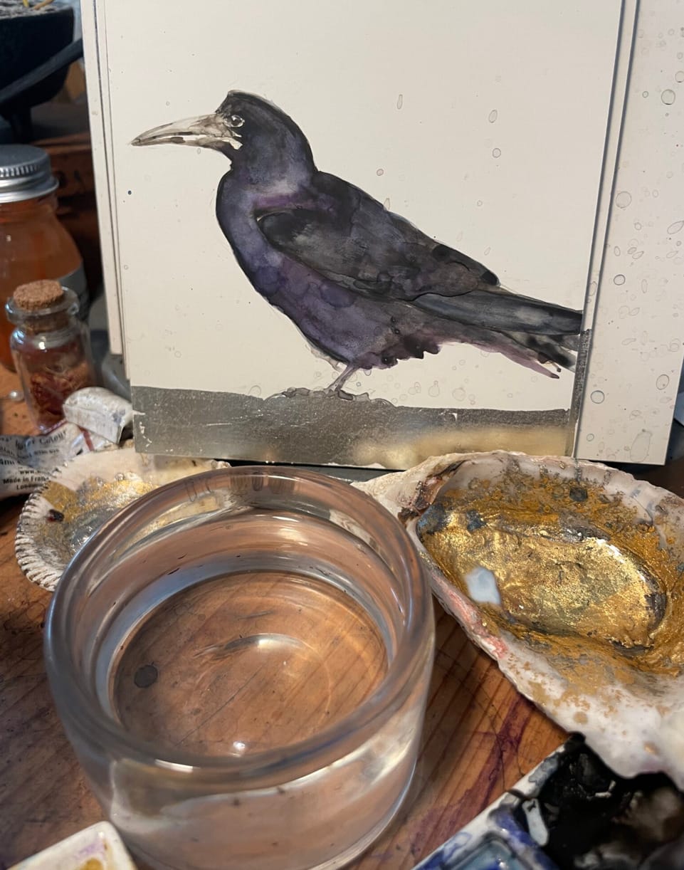 Jackie Morris Painting of a Bird with oyster shells and painting items around it